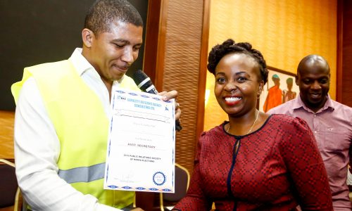 Brian Weke, CEO of Capacity Building Agency Consulting Ltd., (L), as he officially declared Vivienne Atieno as the new Assistant Secretary of Public Relations Society of Kenya, (PRSK).